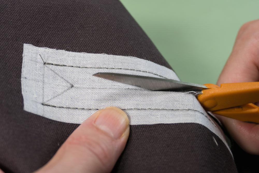 Cutting center line of welt pocket opening.