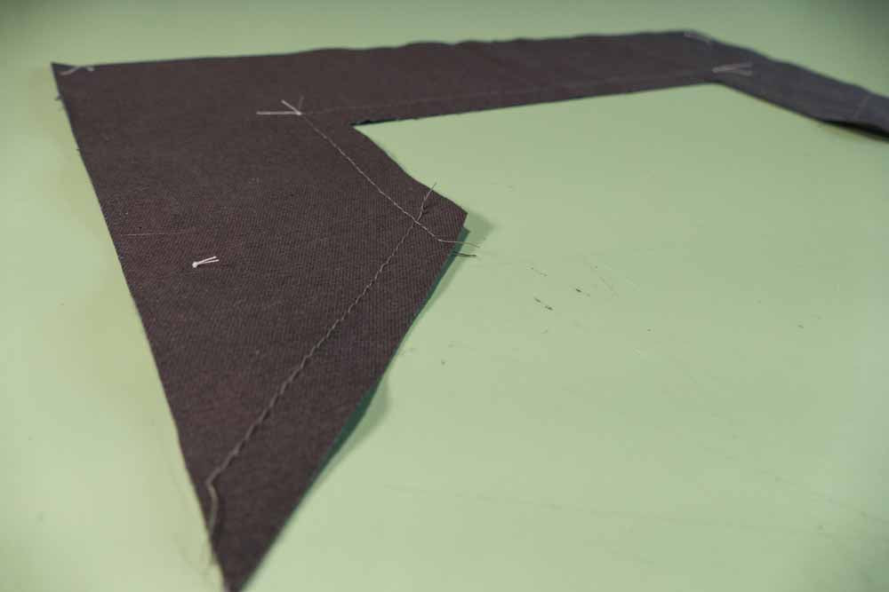 A quick stay stitch made on the machine serves as a guide for turning the edge under.