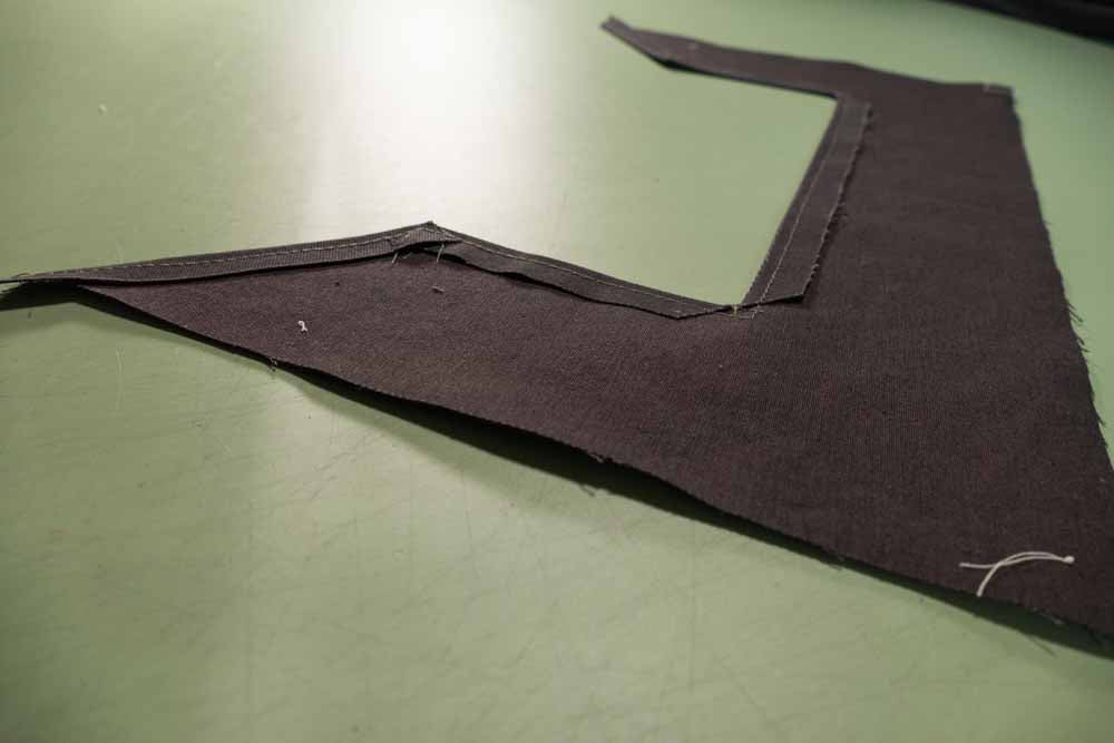 The corners cut and pressed flat. Edge stitch close to the folded edge for a neat and secure finish.