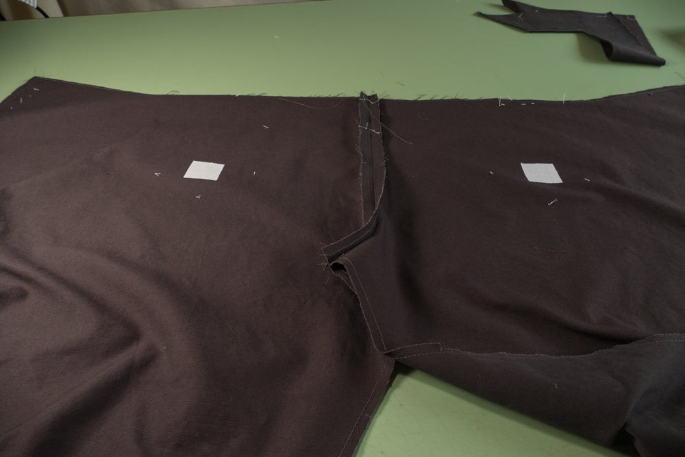 Fusible interfacing ironed to the wrong side of the pants at the slash lines.