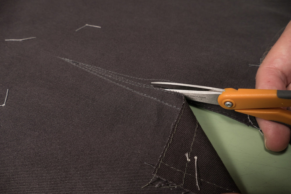 Use the guide line drawn on the front of the pant to start cutting the slash line.