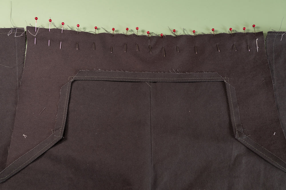The Front Buttonhole Facing pinned to the front of the pant.