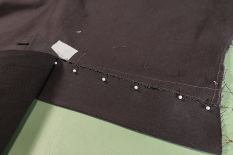 Another view of the Front Dart Gusset Facing aligned and pinned to the pants. 