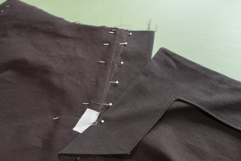 The Front Dart Gusset Facing aligned and pinned to the pants. The Front Buttonhole facing is laying flat.