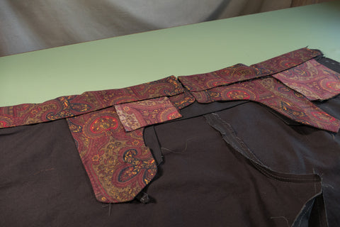 The inside of the pant with the waistband curtain folded down hiding the seam allowances.