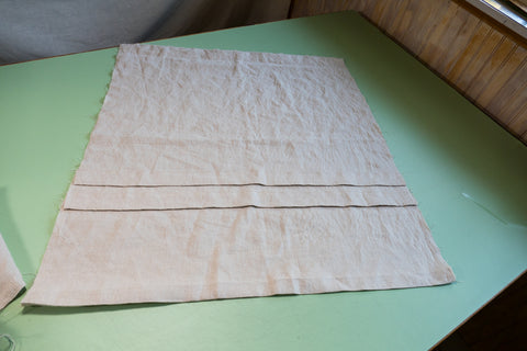 One of the two skirt pieces with it's two pleats ready to be added to the bottom blouse edge.