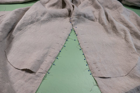 Pinning the pocket pieces into the side seams to the skirt side seams.