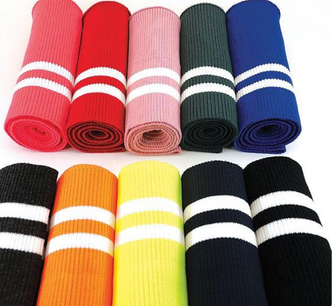 A set of rolled up rib knit fabric in a selection of different colors