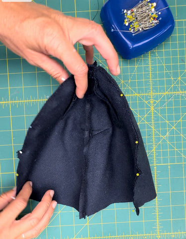 navy blue fabric pinned together for hat.