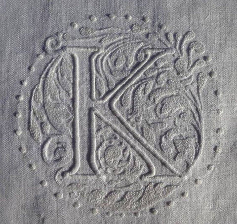 close up of a monogram white on white, letter K