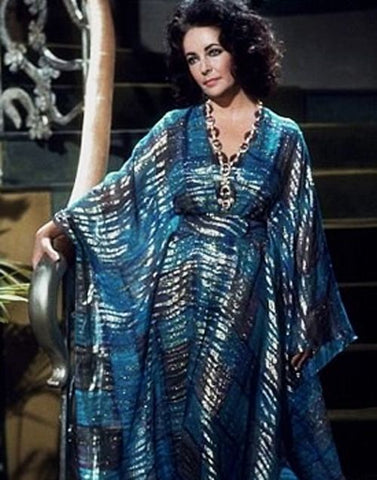 Elizabeth Taylor in a blue long sleeve flowing kaftan