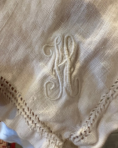 White hankerchief with H embroidered on it in white.