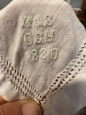 embroidery on a white handkerchief - white letters and date 1830.