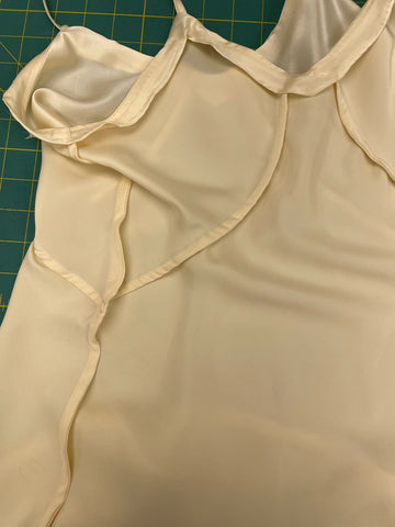 A silk slip is turned inside out to show that the dress has been finished with French seams.