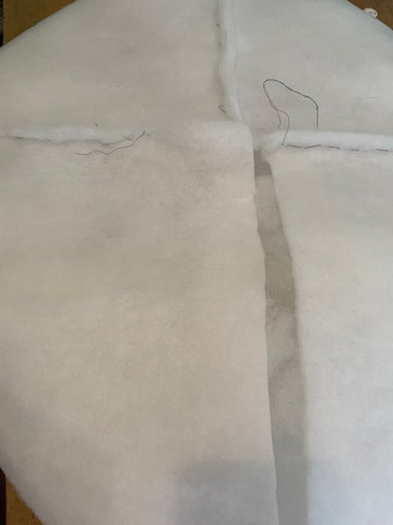 Stitching seams on a pillow filling.