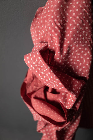red cotton bolt of fabric with white polka dots