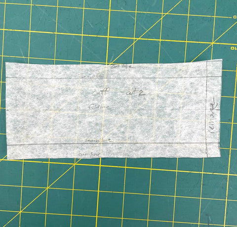 white pattern piece on a green cutting mat
