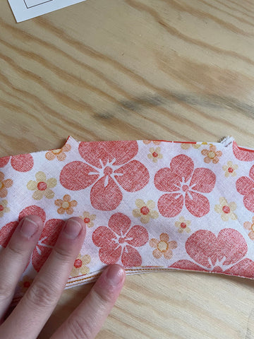 understitched yoke assembly with right sides of orange floral fabric together.