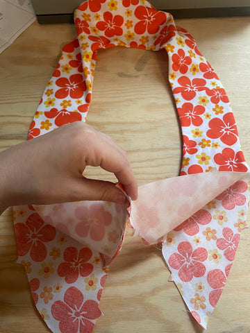 putting the pointed ends of the yoke assembly together.  Orange floral fabric in an oval