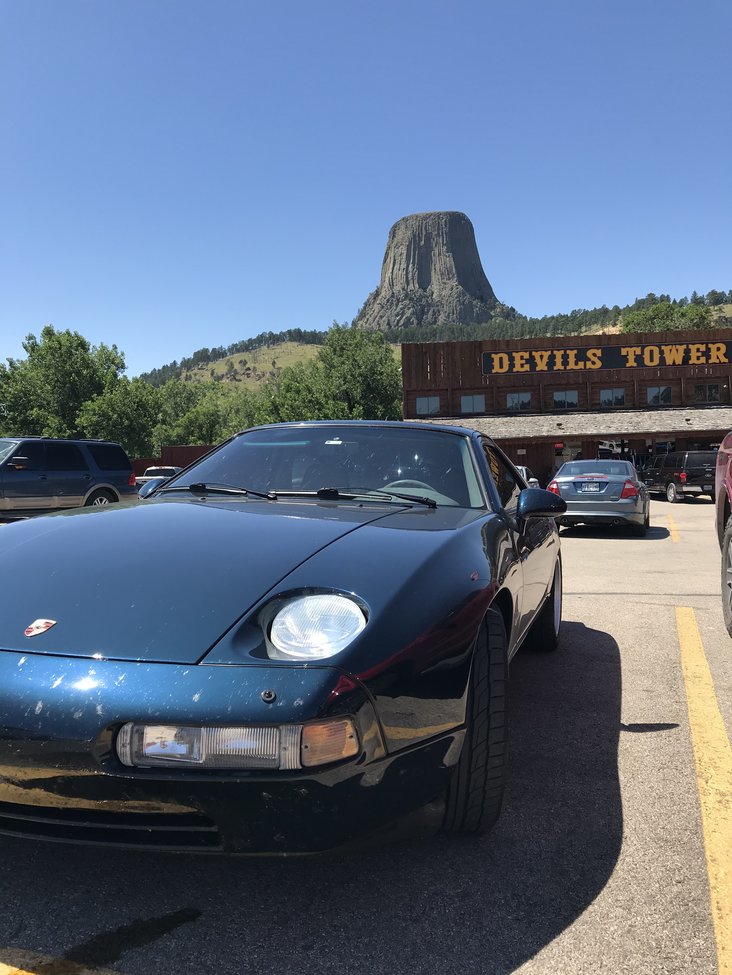 sharks in the badlands 928s event black 928 with mountain in the background