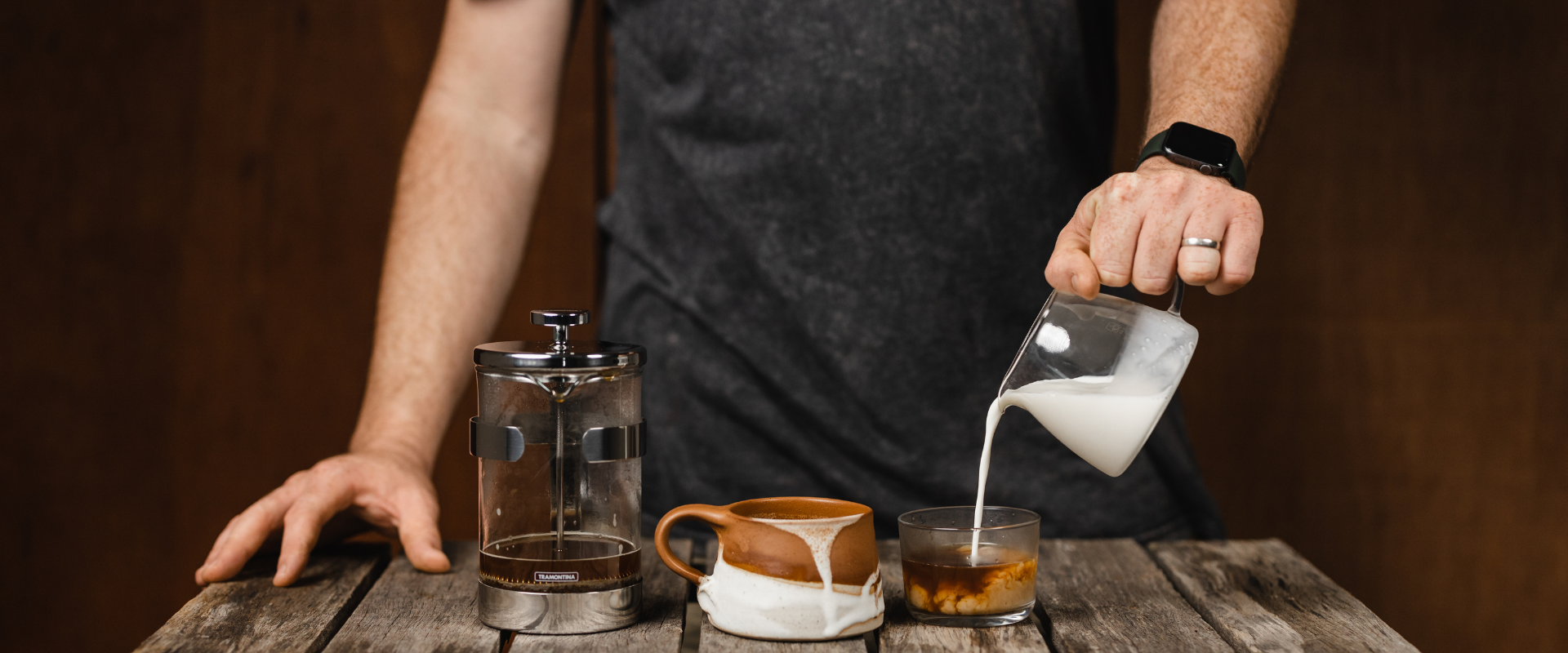 pouring milk into a cup of coffee