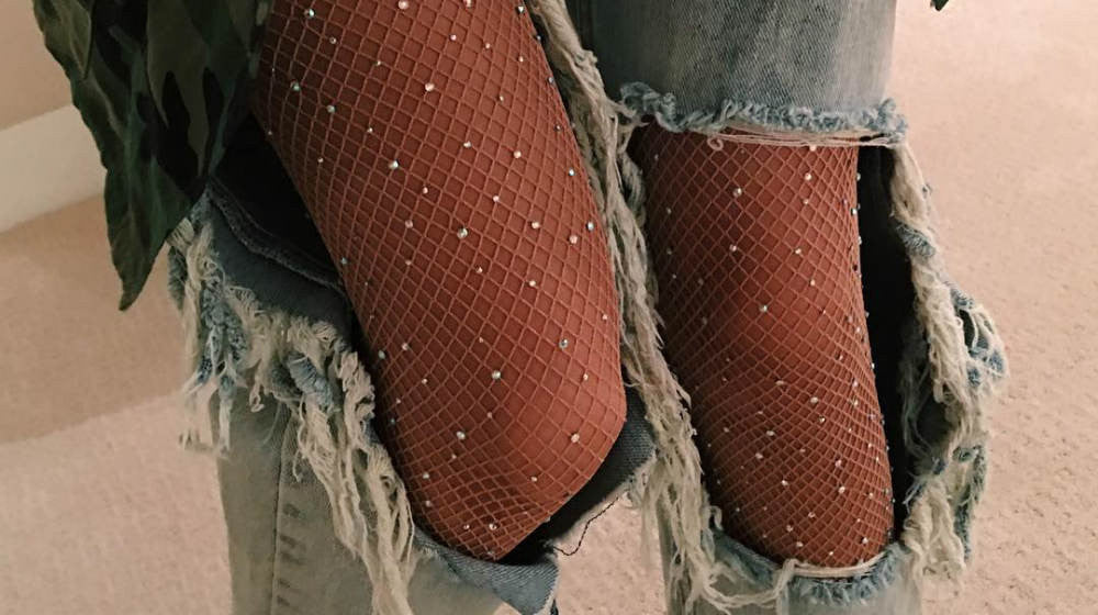 fishnet under ripped jeans