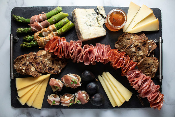 full cheese board on slate with pairings