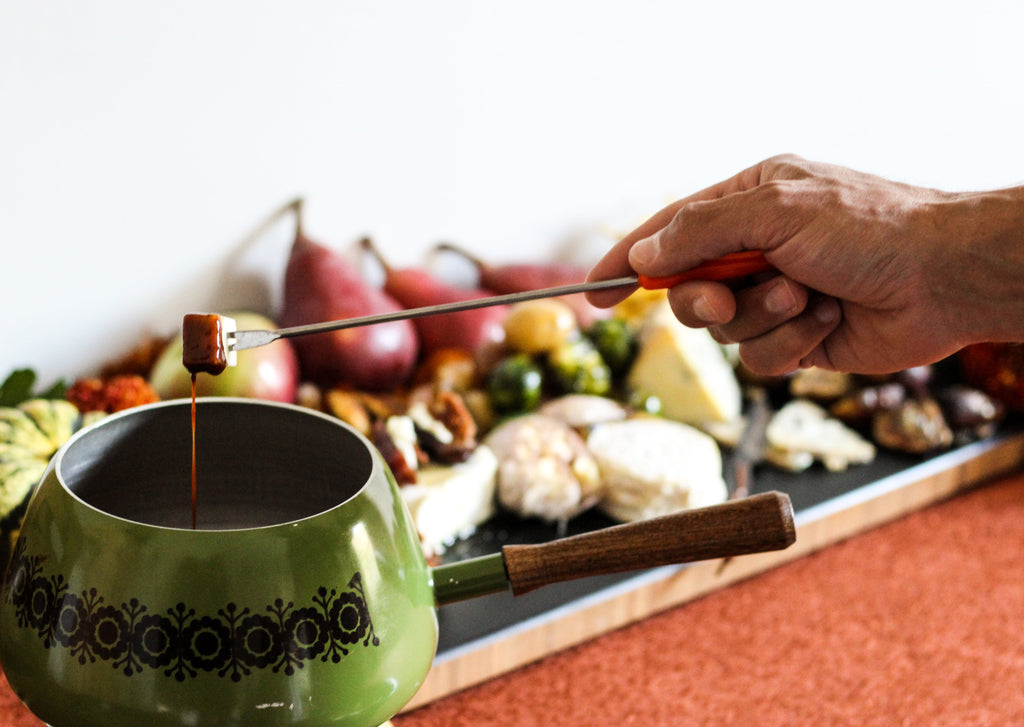 fondue pot with skewer and cheese board
