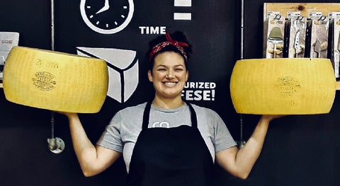 CCC founder whitney roberts with wheels of cheese