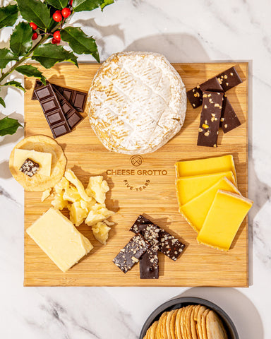 cheese and chocolate on wooden board