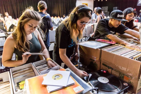 Several people crate digging for vinyl to build a record collection Photography: Courtesy of Discogs