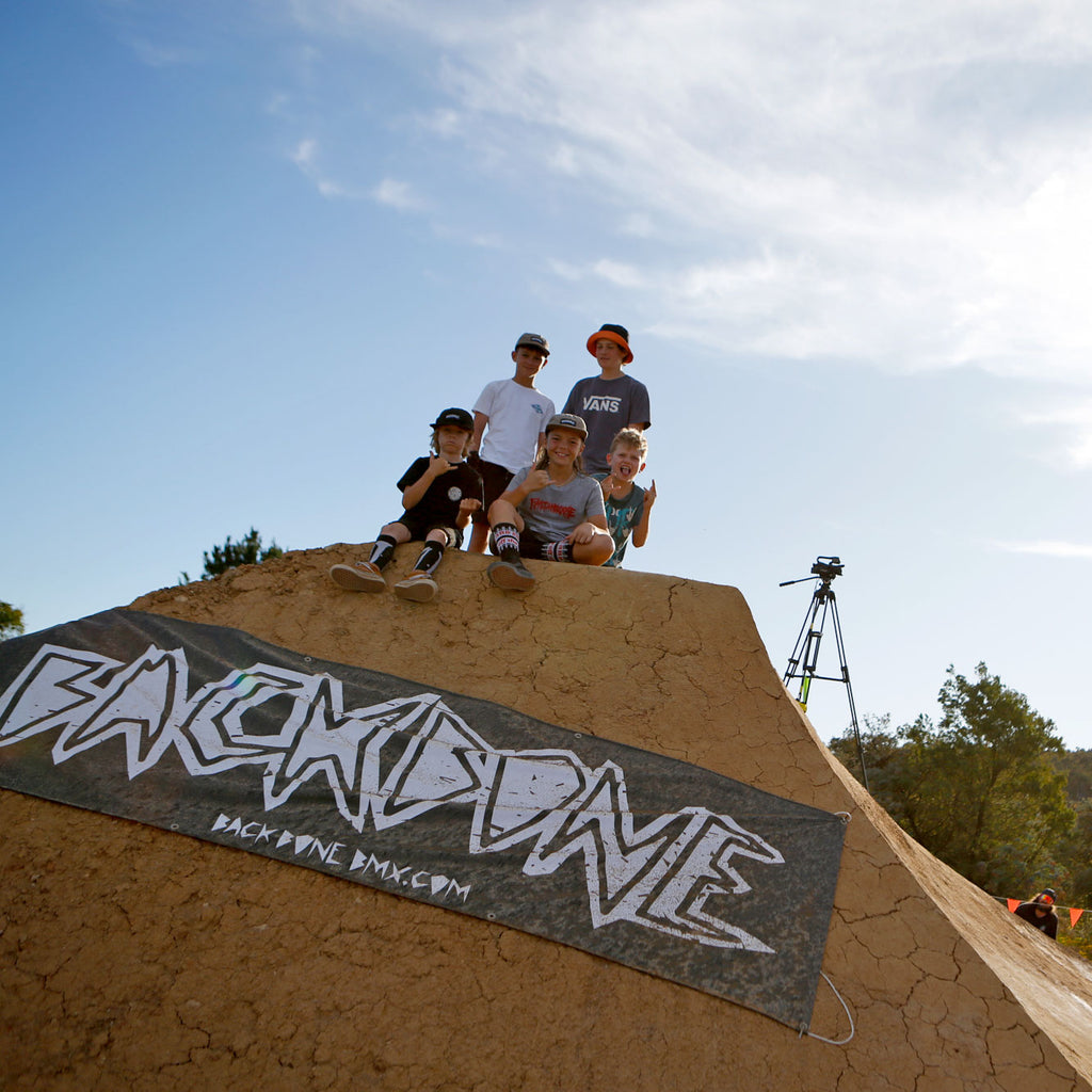 kids bmx hanging out on jump