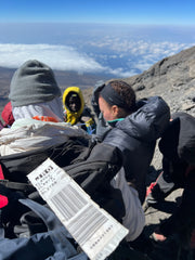 Kristen getting helped down the mountain