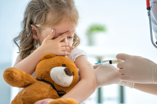 young girl receiving vaccine