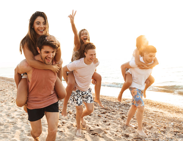 happy young people laughing on a beach