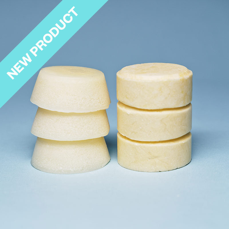 a white round shampoo bar and conditioner bar