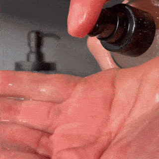 A gif of a woman putting facial cleanser on her face