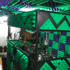 drum room treated with acoustic panels and bass traps - kelly green and purple
