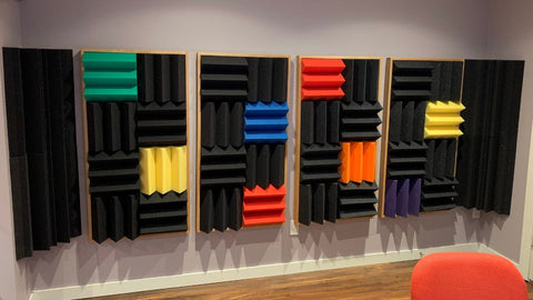 acoustic foam wedge panels on the back wall of a recording studio