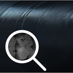 picture of a vinyl record with a magnifying glass showing picture of a groove from a vinyl record close up