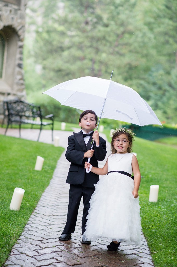 Umbrella fun with flower girl and ring bearer. Find umbrellas for rent/sale at weatherornotaccessories.com | Wedding Planner: Sapphire Celebrations | Photography: Jamee Photography
