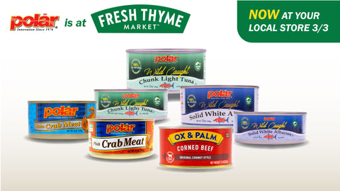 Display of Polar canned products on a white background with two cans of Polar chunk light tuna, two cans of Polar albacore tuna, Polar white crab, Polar pink crab, Ox & Palm corned beef. At the top is written Polar is at Fresh Thyme starting March 3rd.