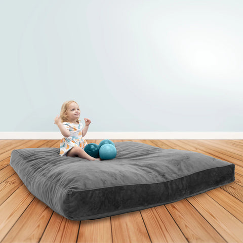 A baby girl playing on a crashpad