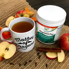 Hot Spiced Fizz Cider in a mug next to a tub of Ionic-Fizz Magnesium Plus