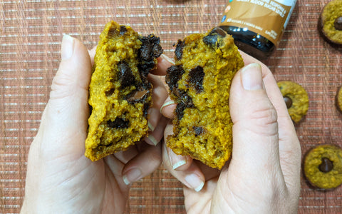 hands breaking open a Pumpkin spice muffin to show inside
