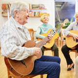 Elderly adults learn to play guitar.