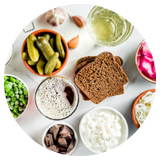 several bowls of foods that contain probiotics including pickles and cottage cheese