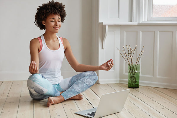 woman finds time to meditate at home