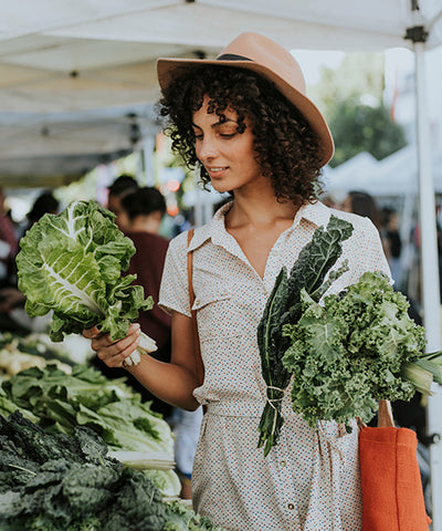 young woman shops produce at the farmer's market