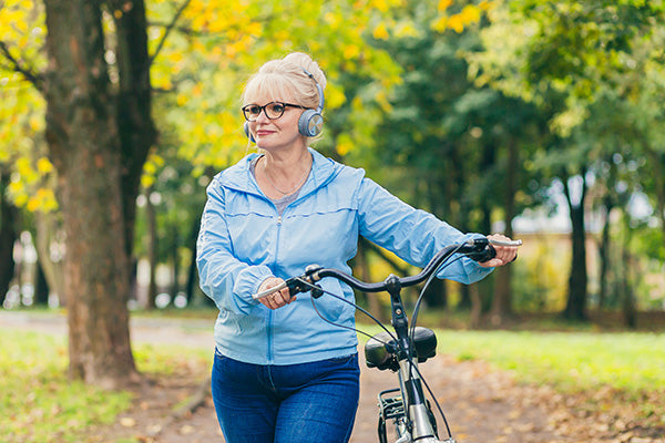 senior woman enjoys biking in the park